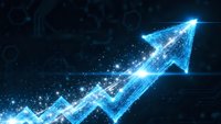 Glowing blue digital arrow pointing upward with sparkling particles and light effects on dark background representing growth and success in business.