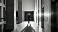 Professional businessman in elegant suit standing in modern corporate hallway with dramatic lighting and contemporary architecture for business concepts.