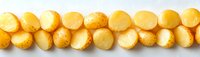 Row of golden round baked mini cheese bread rolls on white background, traditional Brazilian pao de queijo arranged in line, fresh homemade snack.