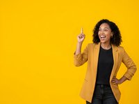 Young woman with dark curly hair and medium skin tone wearing mustard blazer pointing upward with idea gesture against bright yellow background for business and marketing campaigns.