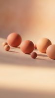 Abstract geometric spheres in warm peach tones with soft shadows on minimalist surface for modern design and branding projects.