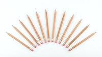 Row of wooden pencils with pink erasers arranged in fan pattern on white background isolated for design projects and educational materials.