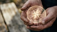 Hands holding glowing compass with golden light rays for navigation and direction finding in outdoor adventure and exploration concepts.