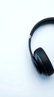 Modern black wireless headphones on clean white background for music streaming and audio technology concepts.