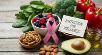 Healthy nutrition concept with pink ribbon, fresh vegetables, berries, nuts and avocado on wooden background promoting wellness and balanced diet.