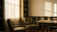 Cozy reading corner with vintage leather chairs and wooden table in warm sunlit library interior with bookshelves and natural window light for home decor.