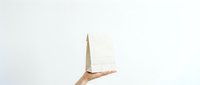 Hand holding wooden pyramid on white background isolated for design and presentation use.