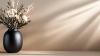Modern black ceramic vase with white dried flowers on wooden surface with natural sunlight shadows creating minimalist home decor composition.