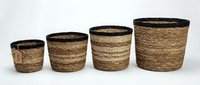Set of four woven jute storage baskets in graduated sizes with black trim, natural fiber home organization containers for modern decor.