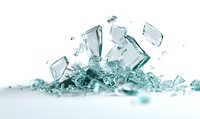 Shattered glass fragments with water splashes on white background, creating dynamic composition of transparent shards with blue-green tint.