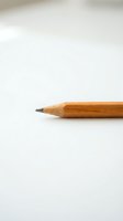 Single wooden pencil with graphite tip on clean white background for office supplies, education and writing concepts.