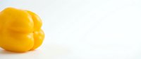 Fresh yellow bell pepper isolated on white background, suitable for food, cooking, nutrition, and recipe design projects.
