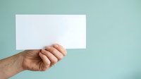 Male hand holding blank white card against turquoise background, suitable for business messaging, advertising, and promotional campaigns.