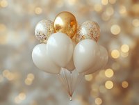 Elegant white and gold glitter balloons floating against soft bokeh background create festive party atmosphere for celebrations and special occasions.