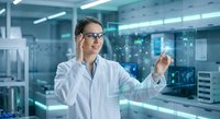 Female scientist in white lab coat working with holographic interface technology in modern research laboratory for medical innovation.