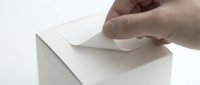 Hand inserting white envelope into ballot box slot for voting, election, survey, or feedback collection concept.