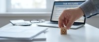 Business professional completing tax return form on laptop with wooden stamp for financial documentation and accounting services.