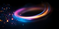 Glowing spiral light trail with pink, blue and orange neon colors swirling on black background, surrounded by luminous particles and bokeh effects.
