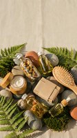 Natural organic spa products with fern leaves and stones on linen background for wellness beauty treatments and eco-friendly skincare routines.