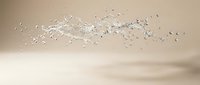 Clear water splash with droplets frozen in motion against soft beige background for refreshing beverage and hydration concepts.