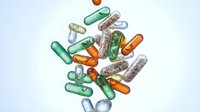 Colorful pharmaceutical capsules and pills scattered on white background for medical healthcare and supplement advertising designs.