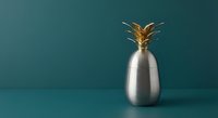 Modern metallic pineapple decoration with golden crown on teal background for contemporary interior design and luxury home decor concepts.