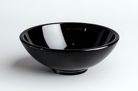Minimalist black ceramic bowl on white background, elegant round shape with glossy finish, isolated for product photography and design projects.