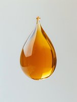 Golden amber liquid drop suspended in mid-air with tiny bubbles against light neutral background, showcasing viscosity and transparency for cosmetic and oil advertising.