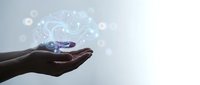 Hands holding glowing digital brain with neural network connections representing artificial intelligence and machine learning technology concepts.