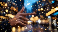 African American hands reaching upward against blurred city lights and falling snow, creating magical winter atmosphere with warm golden bokeh and blue accents.