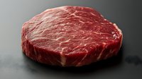 Fresh raw beef ribeye steak with marbled texture on dark background, premium cut of meat showing natural fat marbling and deep red color.