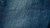 Close-up of blue denim fabric texture with visible weave pattern, suitable for fashion, textile, and apparel design projects.