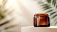 Empty amber glass cosmetic jar on white podium with tropical palm leaves shadow background, luxury skincare packaging mockup for beauty product.
