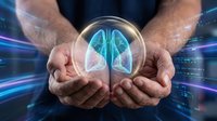 Caucasian male healthcare professional holding glowing lungs in transparent sphere against digital blue background, representing respiratory health, medical innovation, and pulmonary care technology.