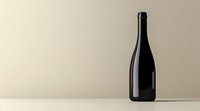Dark wine bottle silhouette against neutral beige background with copy space, minimalist composition for beverage and wine industry marketing materials.