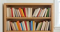 Wooden bookshelf with colorful books arranged on two shelves for home library, education, reading and literature concepts in modern interior design.