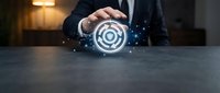 Businessman in dark suit holding glowing target icon with digital particles, representing goal achievement, business strategy, and success in corporate environment.