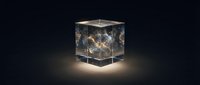 Glowing cube with golden light particles and network connections suspended inside transparent glass block on dark background for technology and innovation concepts.