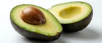 Halved avocado with pit and empty cavity isolated on white background, ready for food photography, cooking, nutrition, and healthy eating design projects.