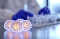 Glowing virus cells in laboratory setting with scientist wearing protective gloves in background, medical research concept for infectious disease study.