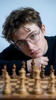 Young Caucasian man with glasses concentrating on chess game, strategic thinking and intellectual challenge concept for education and mental training.