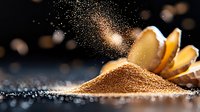 Ground cinnamon powder spilling and scattering with cinnamon sticks on dark background with golden bokeh lights, macro food photography with shallow depth.