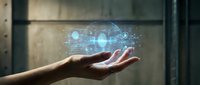 Hand holding futuristic holographic technology interface with glowing digital elements and data visualization floating above palm in modern setting.