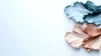Metallic rose gold and turquoise blue decorative leaves on white background create elegant minimal composition for luxury design and modern decor projects.