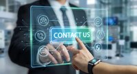 Professional businessman touching contact us button on digital interface with communication icons in modern office environment for customer service.