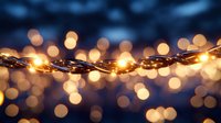 Glowing string lights create magical bokeh effect against dark blue background, warm golden illumination for festive holiday atmosphere and romantic ambiance.