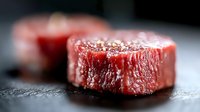 Raw beef steak cuts on dark slate surface with salt seasoning, premium red meat for grilling and cooking in restaurant kitchen or home preparation.