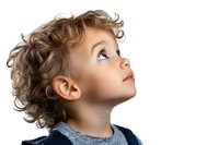 Young caucasian child with curly hair looking up with wonder and curiosity, wearing navy blue sweater against white background, profile view portrait.
