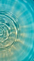 Turquoise water surface with concentric ripples creating mesmerizing circular patterns. Peaceful aqua background with gentle wave motion and light reflections.