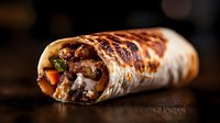 Grilled burrito filled with meat, vegetables and melted cheese on dark wooden background, close up view showing texture and filling details.
